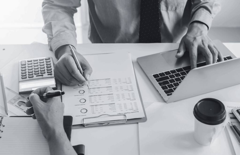 People examine documents to analyze recruitment metrics.