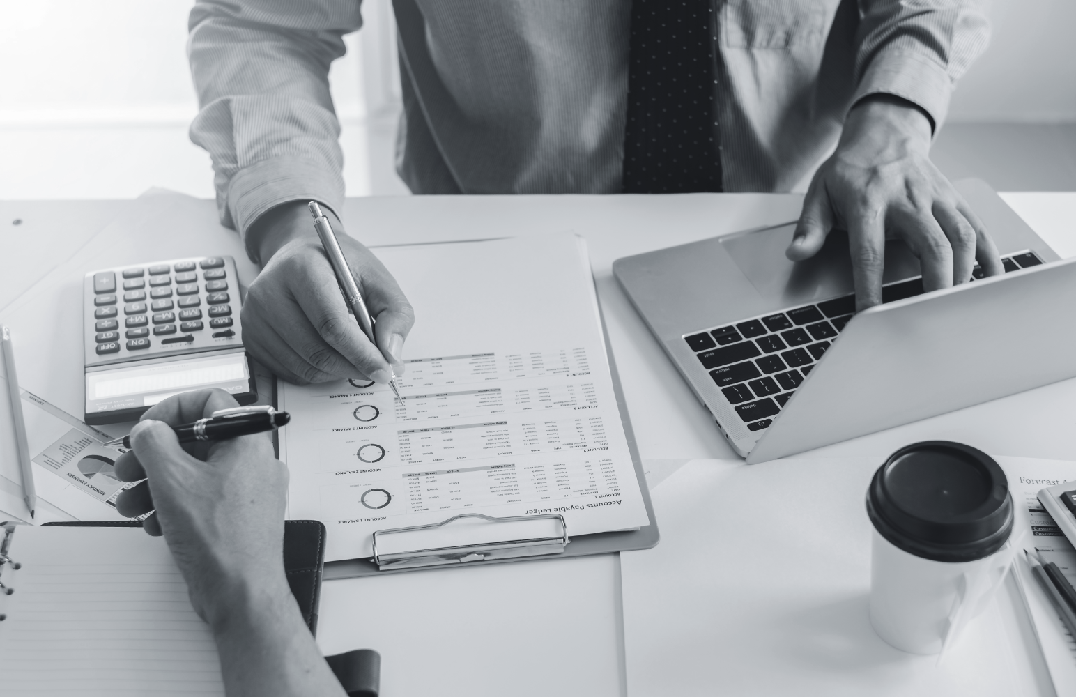 People examine documents to analyze recruitment metrics.